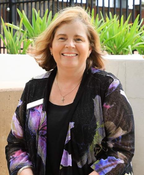 Portrait of Mrs Sally Smith, Principal, smiling outdoors in school setting